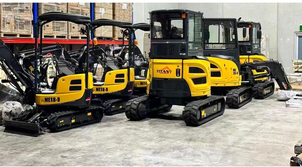 Titan compact excavators lined up in the warehouse ready for hire