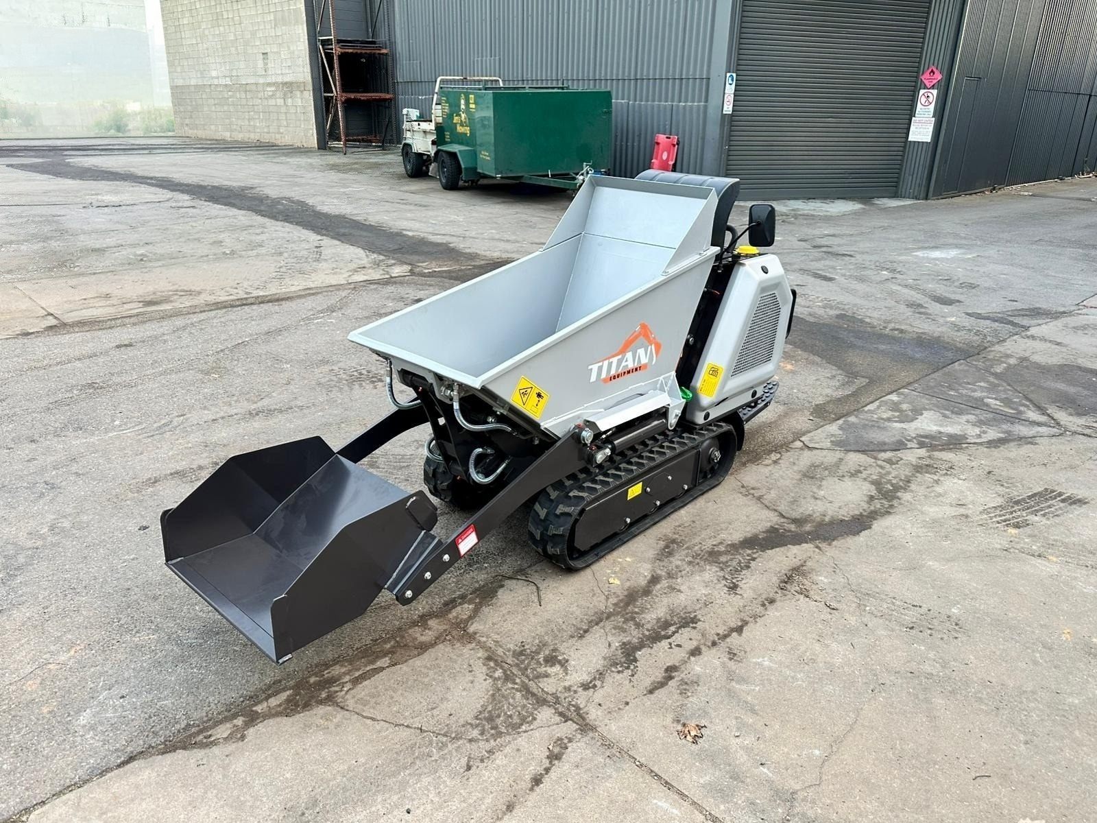 Titan mini dumper in stock yard with loader bucket